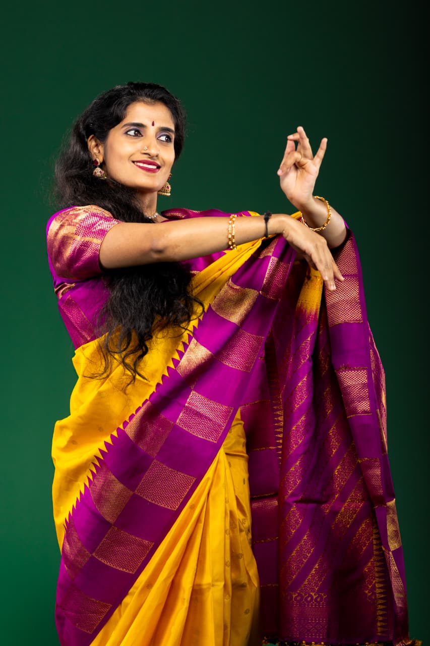 Prathiba in a bright pink and gold classical dance costume